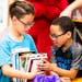 Then-second-graders Dustin Lee, left, and Jayden Buchanan compare books at a book fair in Minneapolis in 2018.