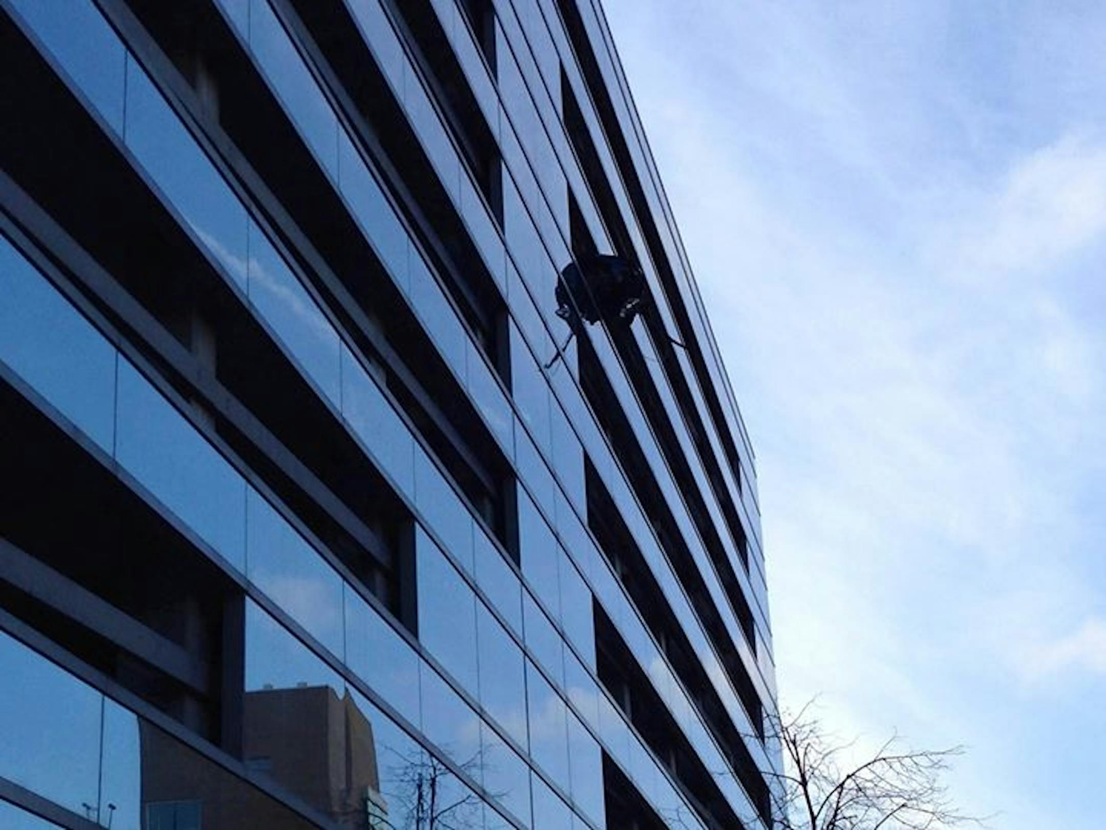 A car dangled Friday morning from the upper levels of a Mayo Clinic parking ramp in Rochester, Minn.