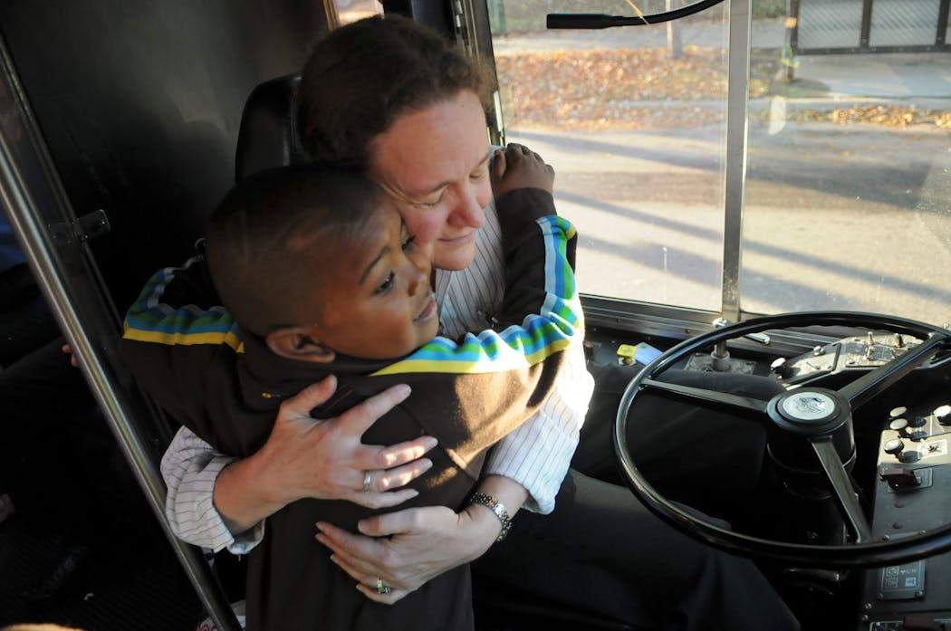 In 2011, when Melanie Benson had been driving for 35 years, Sayvon Jackson, 4, gives her a hug. He had a hug for Benson when he got on and off the bus. Benson had Sayvon's father as a rider when he was a teenager. 