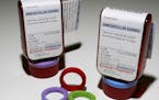 Prescription bottles and colorful rings that make up the ClearRx prescription system are shown in New York Wednesday, April 27, 2005. Target pharmacie
