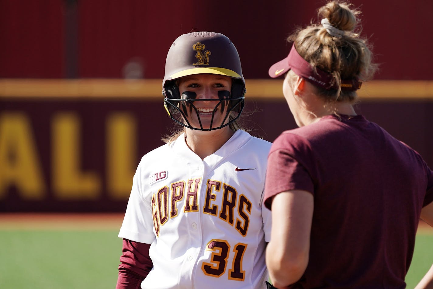 Gophers' Natalie Denhartog (31) joked with her first base coach after getting a base hit. ] ANTHONY SOUFFLE &#x2022; anthony.souffle@startribune.com The Minnesota Golden Gophers softball team played Iowa in a doubleheader Friday, April 26, 2019 at Jane Sage Coweles Stadium in Minneapolis.