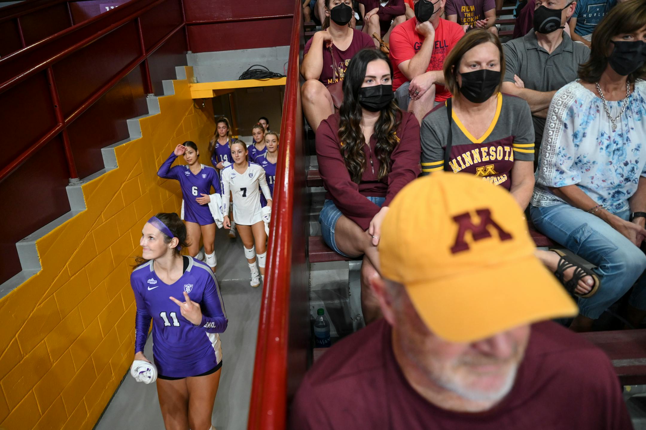 The St. Thomas Tommies, including right side hitter Claire Ricard (11), walked out the tunnel before their match against the University of Minnesota Gophers Thursday night.
