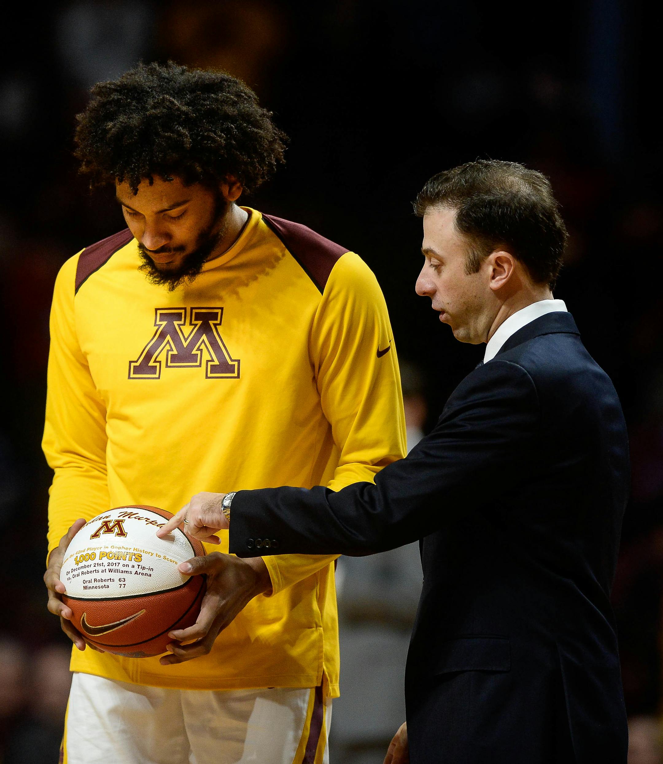 In a pre-game ceremony, Minnesota Gophers forward Jordan Murphy (3) was recognized for scoring his 1,000th point as a Gopher alongside head coach Richard Pitino. The Gophers played Florida Atlantic on December 23, 2017.