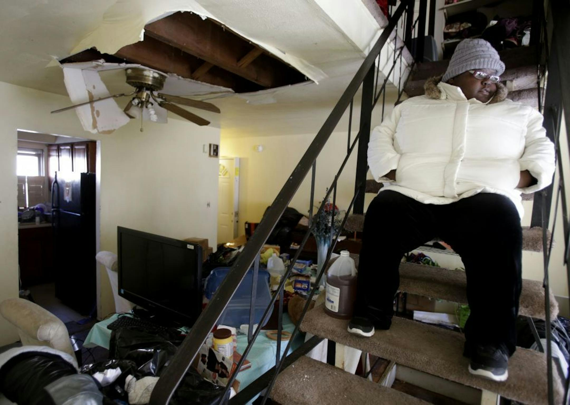 Ayanna Diego looks over her living room while waiting for inspectors at her home, which was damaged by Superstorm Sandy, in the Rockaways section of New York, Thursday, Jan. 24, 2013. Not only was the basement flooded, but water leaked through the roof and damaged the higher floors as well.