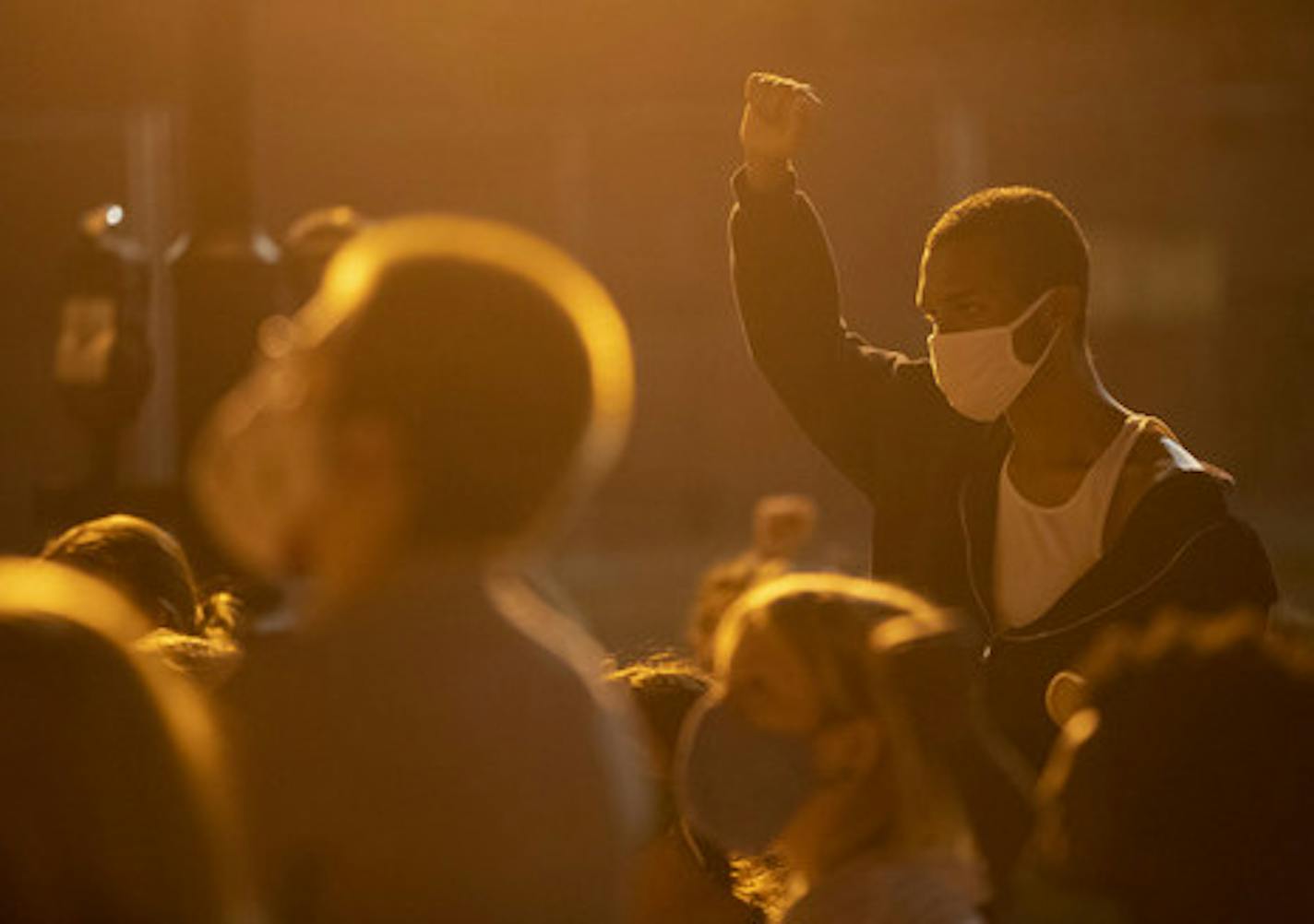 Protesters marched through the streets of Duluth on Wednesday. One raised his fist during nine minutes of silence Wednesday at the Clayton Jackson McGhie Memorial, which pays tribute to three black men who were lynched by a white mob in Duluth in 1920.