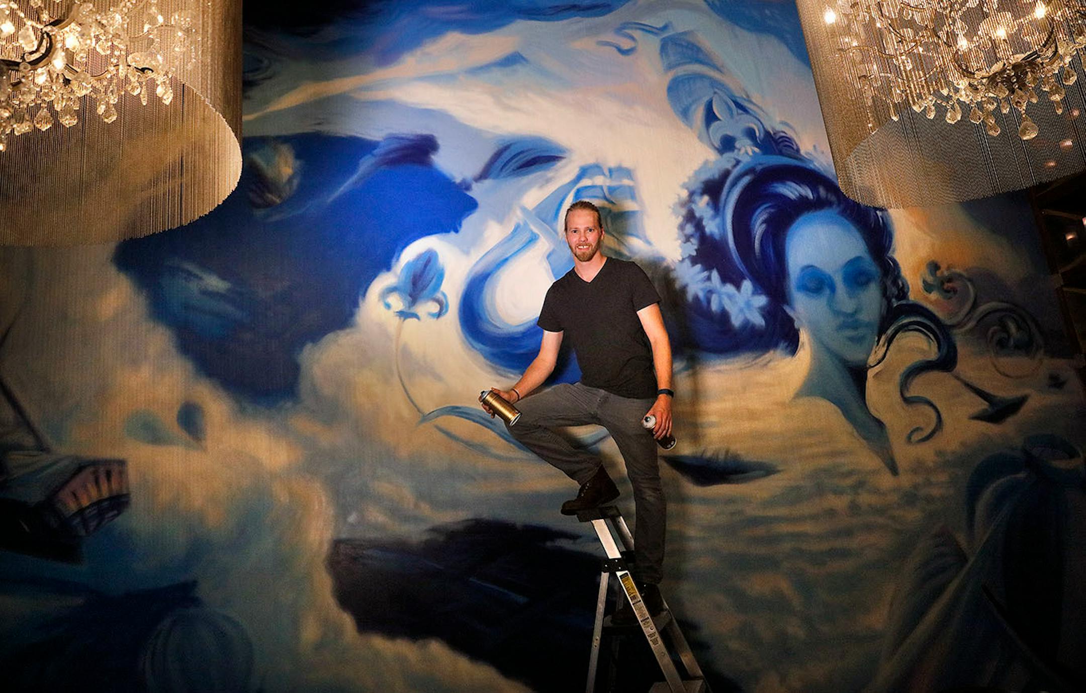 Adam Dennis works on his murals at Coup d'Etat restaurant in Uptown. Dennis' work include Smack Shack and the Pourhouse and is done with chalk and spray paint.