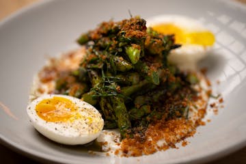 Grilled asparagus, with ranchovy, egg, and potato crunch, as prepared by chef Denny Leaf-Smith at All Saints.