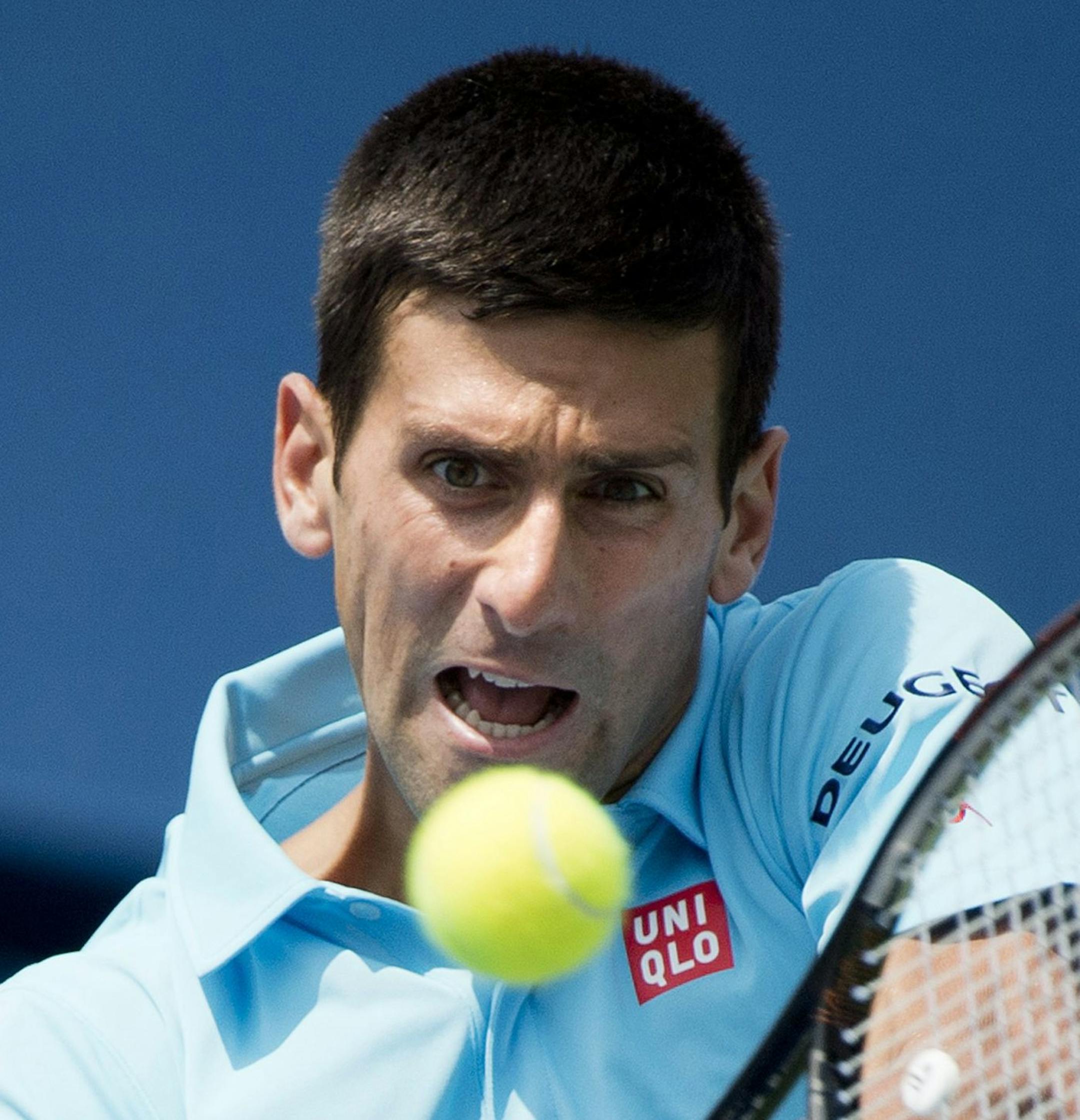 Novak Djokovic of Serbia returns the ball against Gael Monfils of France at the Rogers Cup tennis tournament, Wednesday, Aug. 6, 2014 in Toronto. (AP Photo/The Canadian Press, Nathan Denette) ORG XMIT: MIN2014082300484698