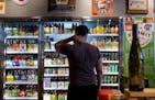 Ryan Youngdale stands in front of the beer fridge at Stinson Wine, Beer, and Spirits. ] COURTNEY PEDROZA ¥ courtney.pedroza@startribune.com July 2, 2