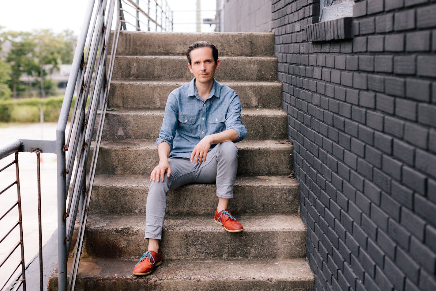 photo of Thomas Mullen, seated on concrete stairs