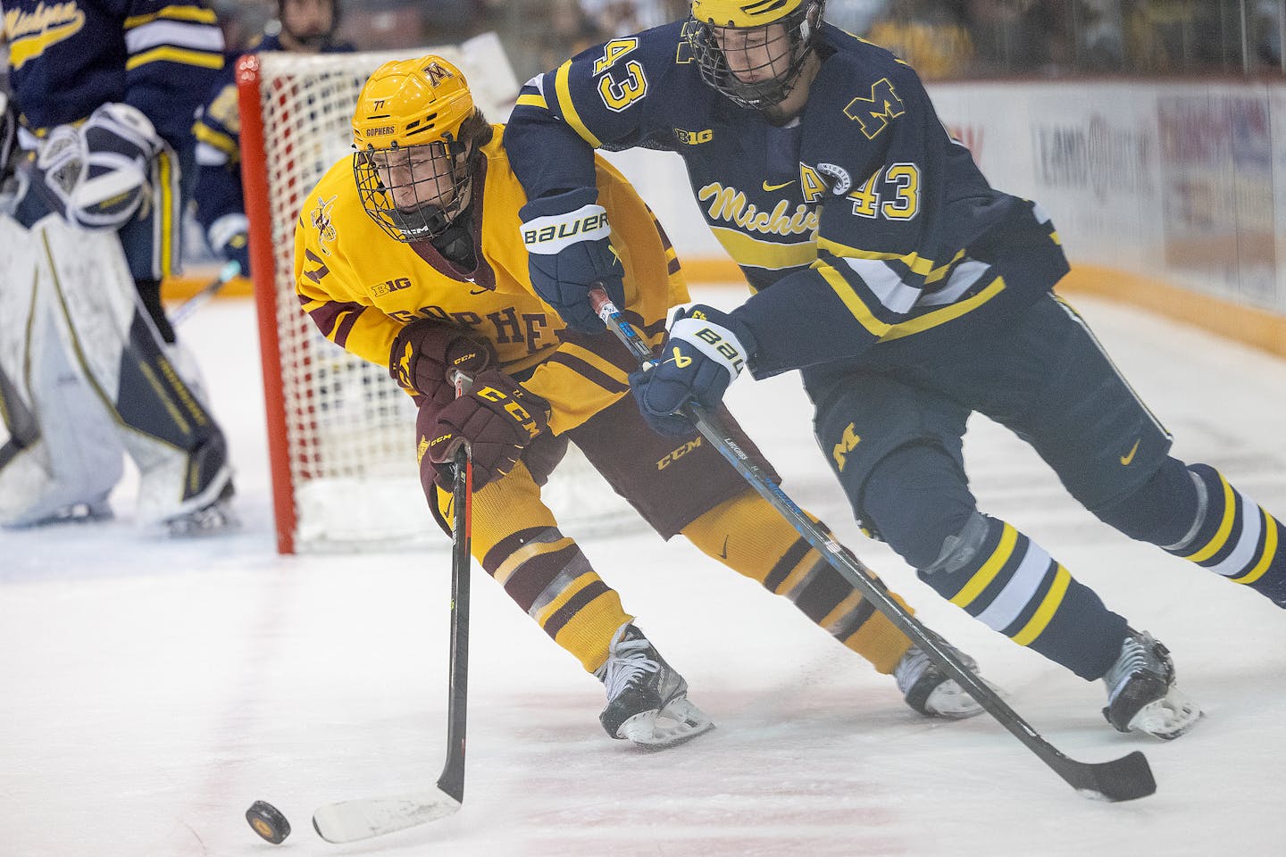 Michigan defenseman Luke Hughes (43) carried the puck against the Gophers.