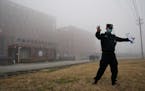 A security official moves journalists away from the Wuhan Institute of Virology after a World Health Organization team arrived for a field visit in Wu