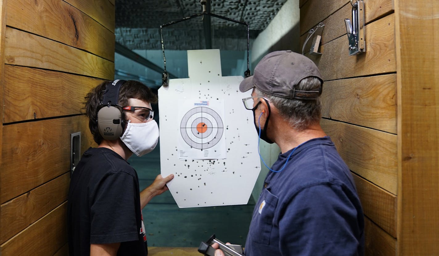 Hunter Woodward, left, talked with his dad Gary Woodward after they fired Gary's handgun during Hunter's first trip to the shooting range Wednesday afternoon. ] ANTHONY SOUFFLE • anthony.souffle@startribune.com Customers fired guns on the shooting rage at the Stock & Barrel Gun Club Wednesday, Sept. 2, 2020 in Chanhassen, Minn. Customers are buying up guns and ammunition in droves, motivated by the COVID-19 pandemic and the riots following the George Floyd killing, leaving a significant shortage