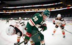 Minnesota Wild right wing Ryan Hartman (38) and Anaheim Ducks left wing Max Jones (49) fought for control of the puck along the boards in the second p