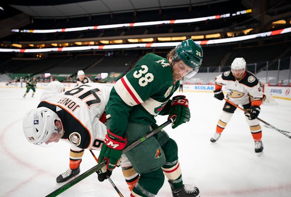 Minnesota Wild right wing Ryan Hartman (38) and Anaheim Ducks left wing Max Jones (49) fought for control of the puck along the boards in the second p
