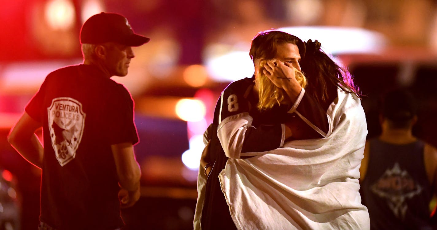 People comfort each other after a mass shooring at the Borderline Bar & Grill in Thousand Oaks late Wednesday night, Nov. 7, 2018. (Wally Skalij/Los Angeles Times/TNS) ORG XMIT: 1245004