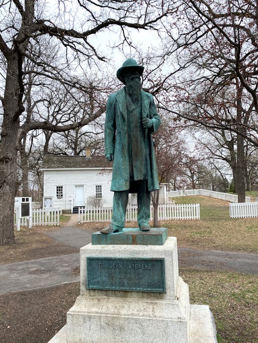 A statue of John H. Stevens is located outside of the Stevens House in Minnehaha Park.