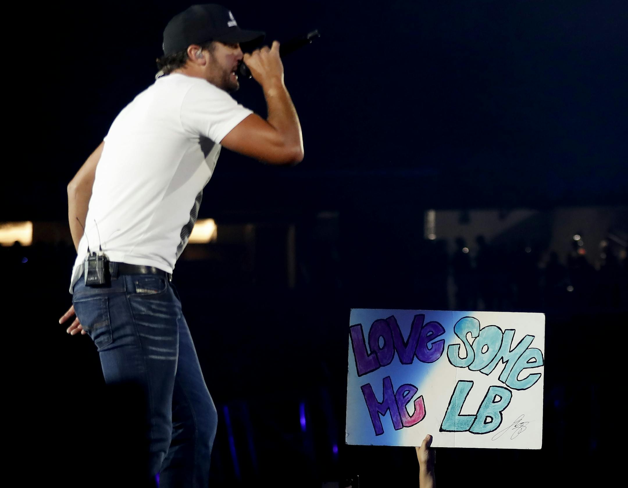 A fan held up a sign as Luke Bryan performed at US Bank Stadium.