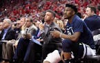 Minnesota Timberwolves guard Jimmy Butler, right, watches from the bench during the second half in Game 5 of the team's first-round NBA basketball pla