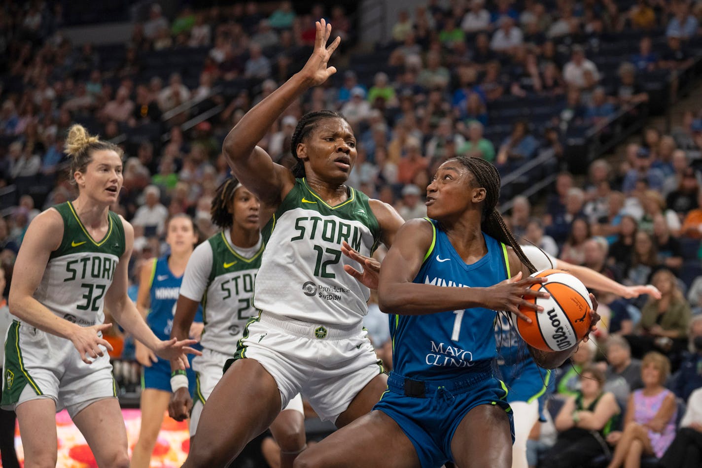 Minnesota Lynx guard Diamond Miller (1) looks for a shot as Seattle Storm forward Dulcy Fankam Mendjiadeu (12) defends during the first quarter of an WNBA basketball game Sunday, Aug. 20, 2023, in Minneapolis. (Jeff Wheeler/Star Tribune via AP)