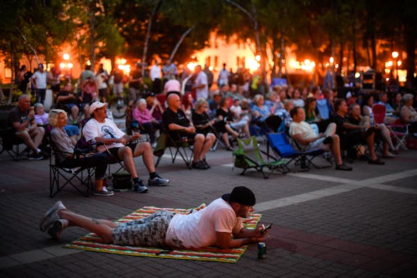 Fans spread out and sometimes sprawl out in Mears Park on Thursday nights in summer for the Lowertown Sounds concerts.