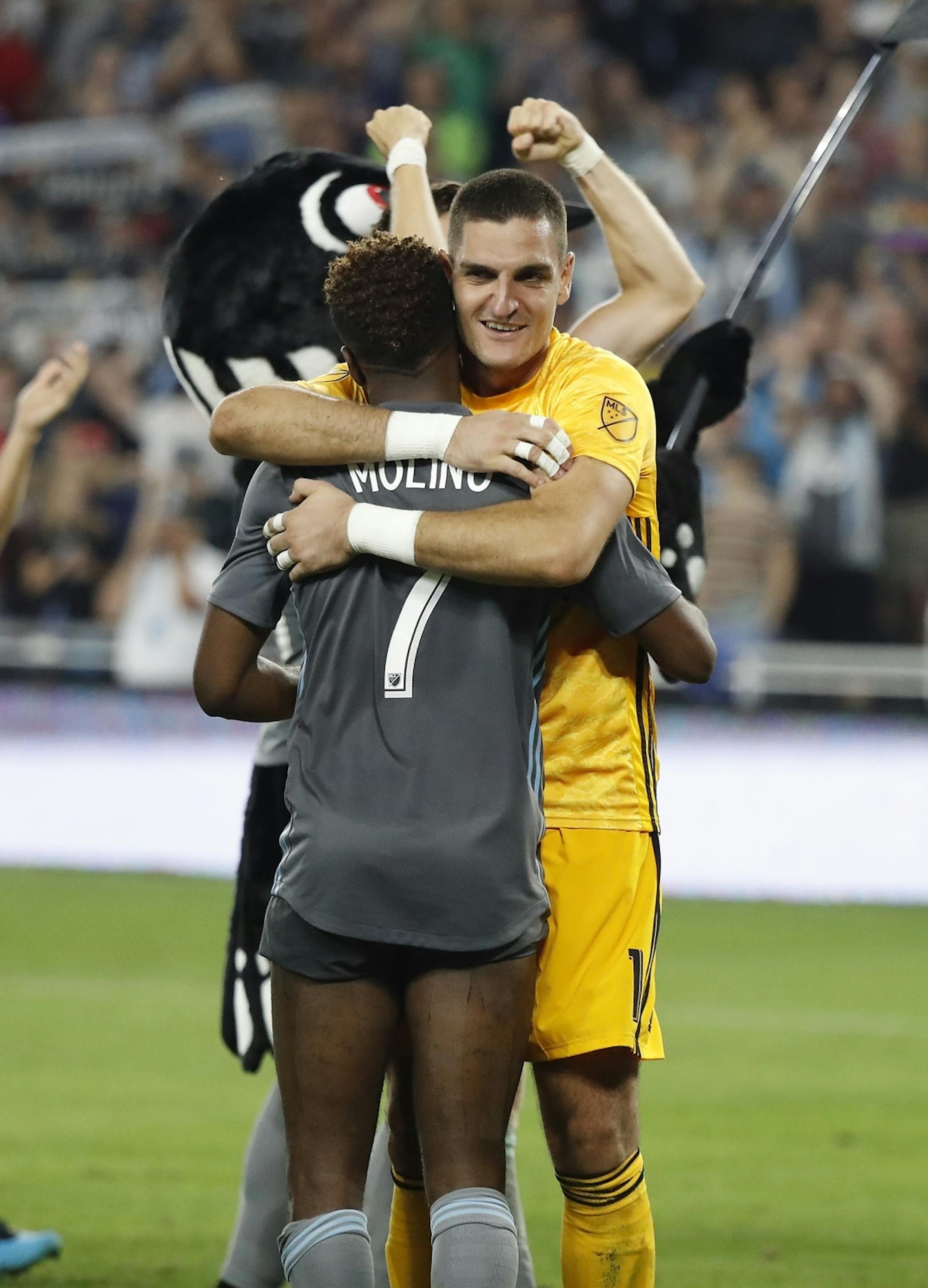 Minnesota United goalkeeper Vito Mannone (1) and Minnesota United midfielder Kevin Molino (7) embraced after their win.