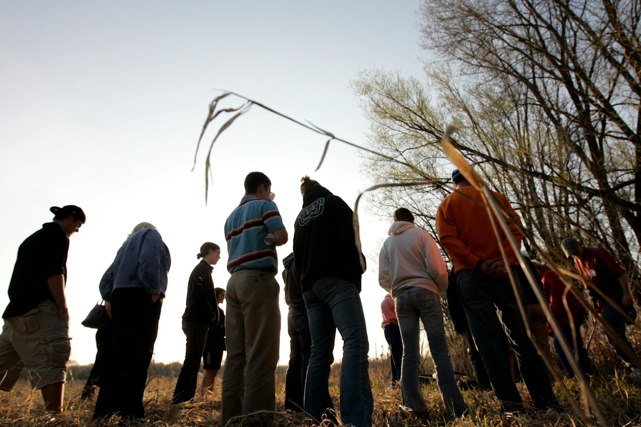 A group of volunteers about to work in a wetland near Minnetonka City Hall listened to instructions from field coordinator Brandon Burns. Volunteers say they like the work because it is a first-person lesson on the importance of healthy wetlands to the environment.