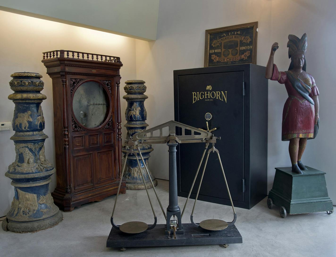 Brian Witherell, a regular appraiser on "Antiques Roadshow," has uncovered many Sacramento finds during his career. A recent auction was devoted to Gold Rush-era antiques. In the background are two gold-gilded lamp posts (from the collection of the late Eppie Johnson) from San Francisco depicting Gold Rush scenes. They flank a gigantic mechanical music box with 27-inch discs. In the foreground is an antique gold scale. At right is a classic cigar store Indian. (Renee C. Byer/Sacramento Bee/TNS)