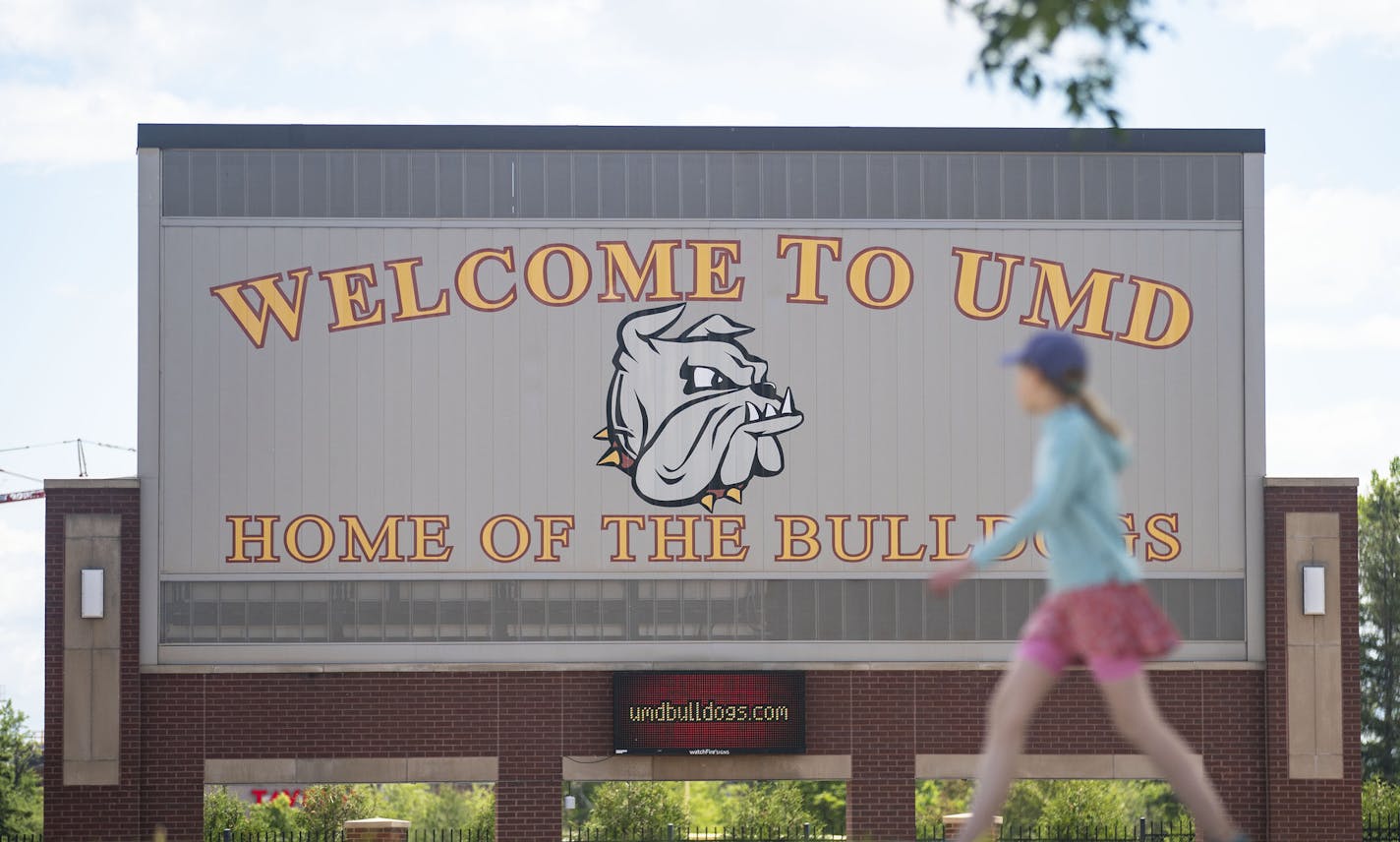 A woman walked past the University of Minnesota Duluth football stadium on Tuesday June 23, 2020. ] ALEX KORMANN • alex.kormann@startribune.com The University of Minnesota Duluth is dropping SAT/ACT test requirement starting with spring and fall 2021 applicants, part of a national trend as colleges grow increasingly competitive amid a shrinking pool of high school graduates.