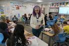 Teacher Midi Hansen helped her fourth-grade students with a math lesson during class Thursday, March 2, at Aquila Elementary School in St. Louis Park.