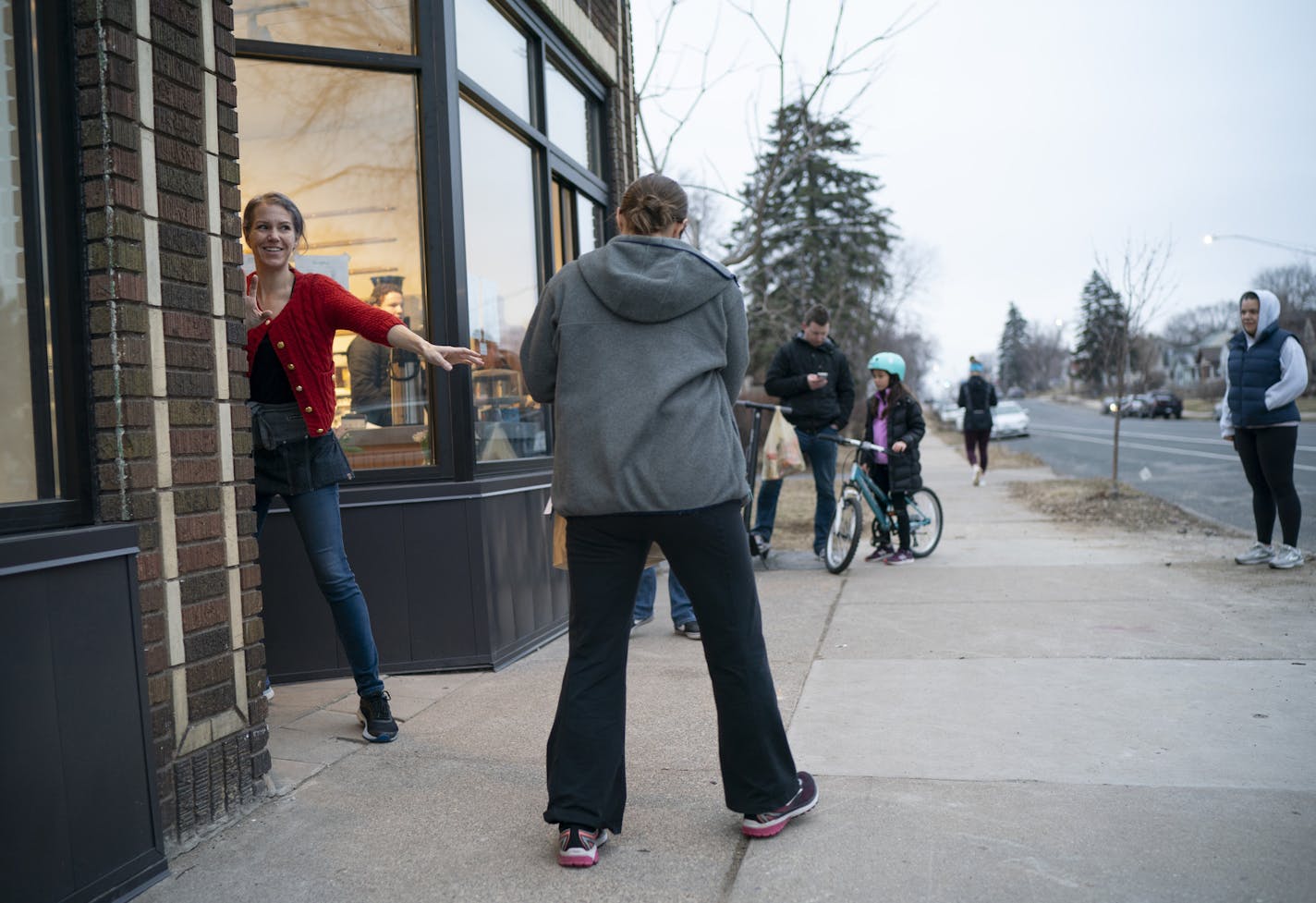 Heather's staffer Zoey Brom-Palkowski handed a takeout order to one of the several customers waiting outside the south Minneapolis restaurant Wednesday night.