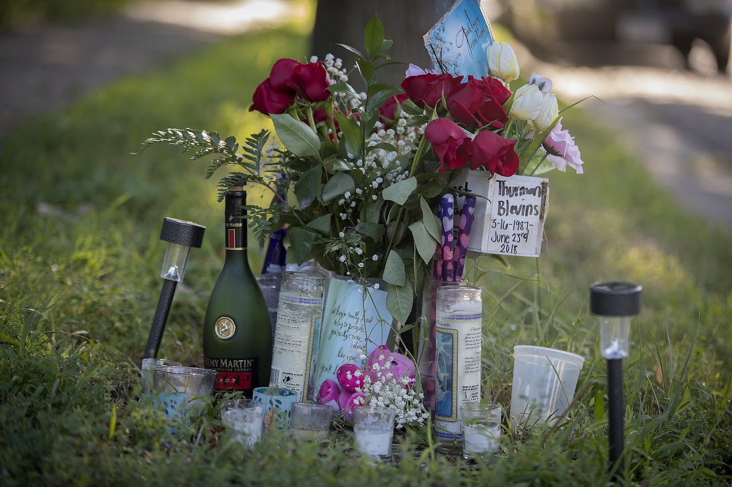 Signs and a makeshift shrine remained on the street corner of N. Camden Avenue and 58th Street in Minneapolis on Monday, a day after the release of the body camera footage in the shooting death of Thurman Blevins.