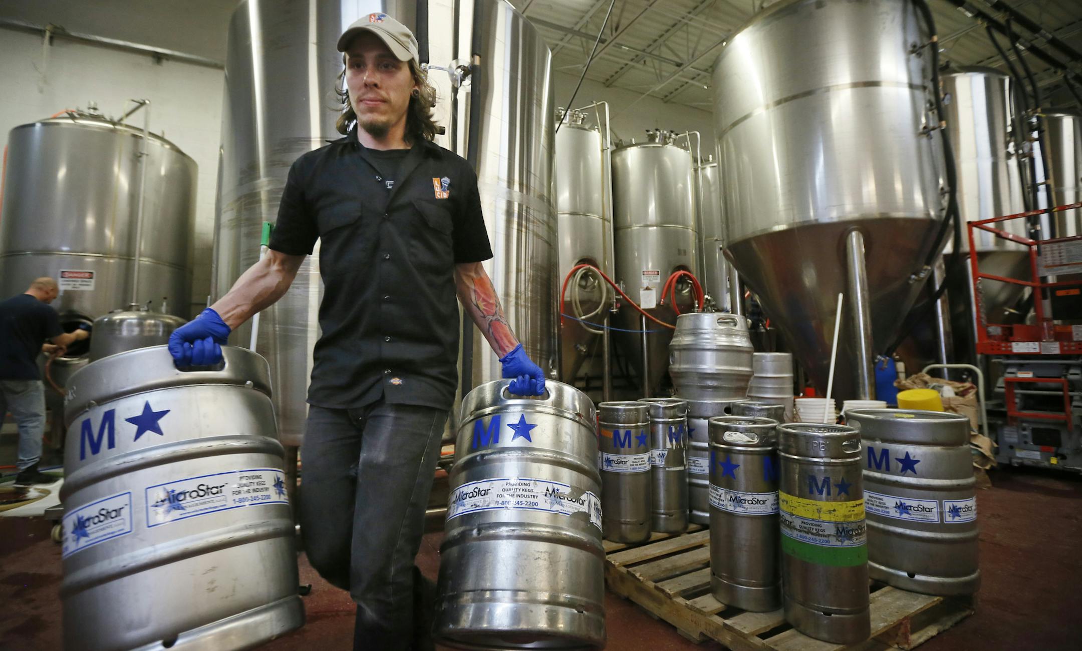 David Schatschneider stacked beer kegs at Lucid Brewing in Minnetonka. Lucid, Bad Weather and Badger Hill Brewing make up a brewing cooperative in Minnetonka, and they just doubled their capacity with new tanks. Now they are worried that the new proposed alcohol tax will threaten their plans to expand. Wednesday May 8, 2013 Minnetonka , MN. ] JERRY HOLT ‚Ä¢ jerry.holt@startribune.com
