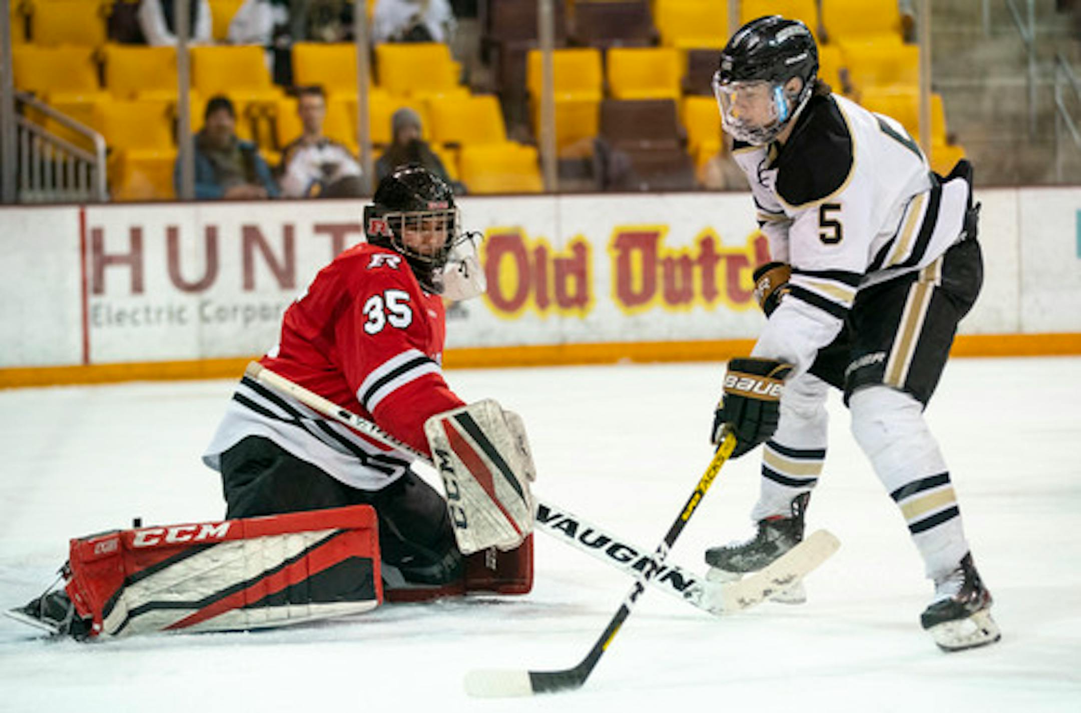 Andover defenseman Wyatt Kaiser, right, shot against Elk River goalie Josh Koziol during sectional play.