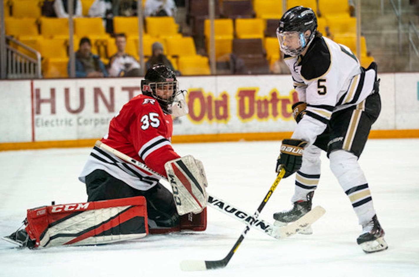 Andover defenseman Wyatt Kaiser, right, shot against Elk River goalie Josh Koziol during sectional play.