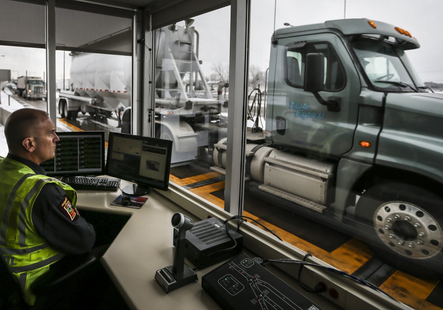 Commercial vehicle inspector Tony Kasella monitored trucks at the St. Croix weigh station on Interstate 94. Of the hundreds of thousands of trucks that go through stations, a fraction are stopped for inspection.