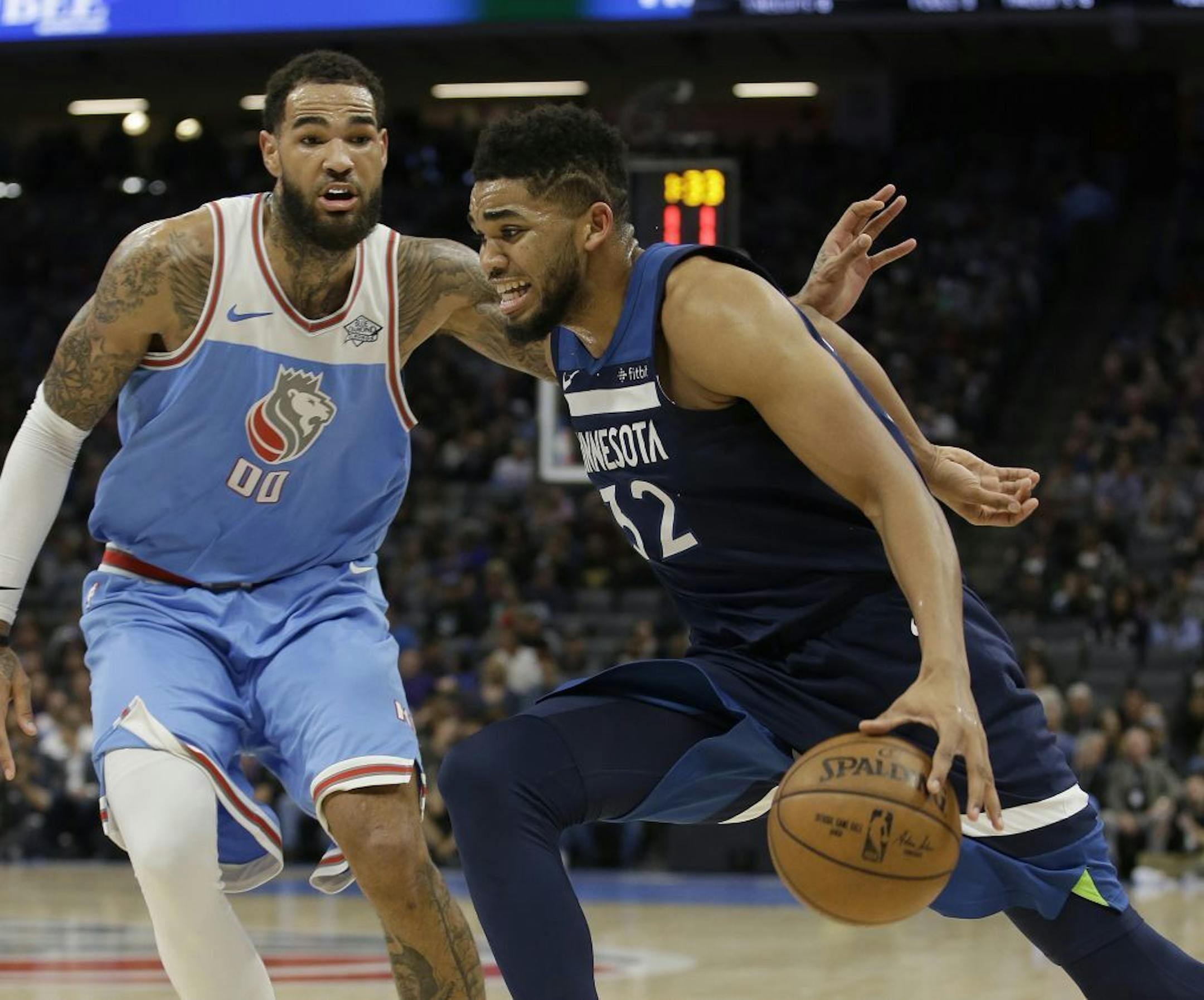 Minnesota Timberwolves center Karl-Anthony Towns, right, drives against Sacramento Kings center Willie Cauley-Stein during the second quarter of an NBA basketball game Monday, Feb. 26, 2018, in Sacramento, Calif.