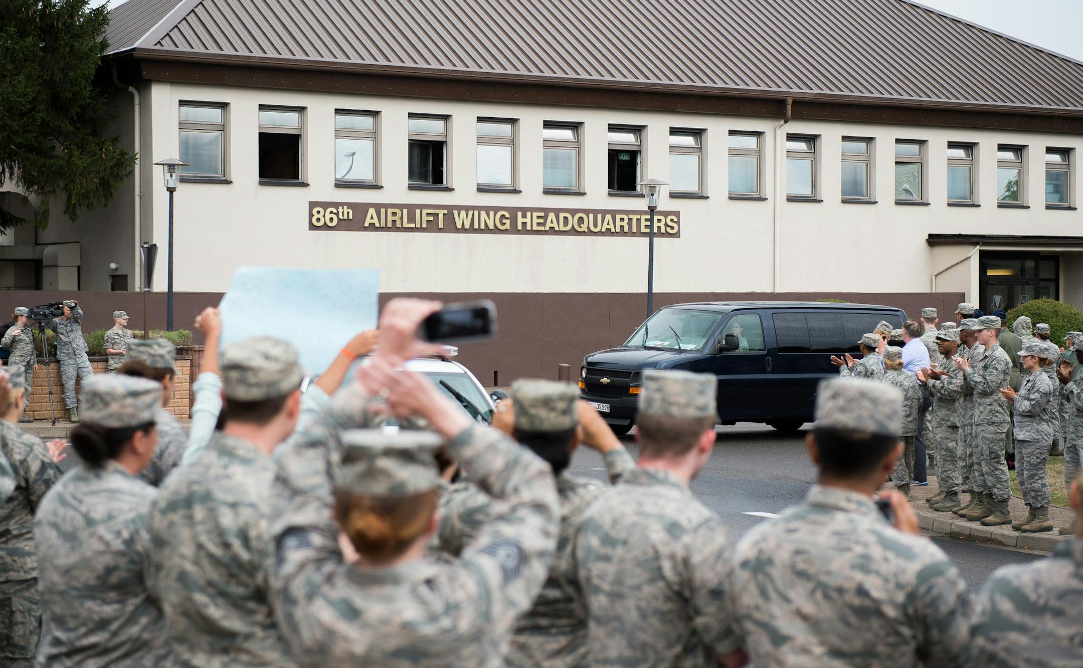 In this Aug. 24, 2015 picture, provided by U.S, Airforce Ramstein , Airman 1st Class Spencer Stone is greeted with a "Heroic Welcome" as he and Oregon National Guardsman Aleksander Skarlatos arrive at Ramstein Air Base, Germany. More than 200 Airmen and their families came out to line the streets and thank Stone and his friends for their bravery. Stone arrived at Ramstein while in transit to Landstuhl Regional Medical Center for follow-on medical treatment. Stone received multiple injuries, all