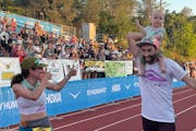 Tyler Green carried his son, Lewis, at the finish of his Western States 100 on Saturday. Celebrating with them was his wife, Rachel Drake, left.