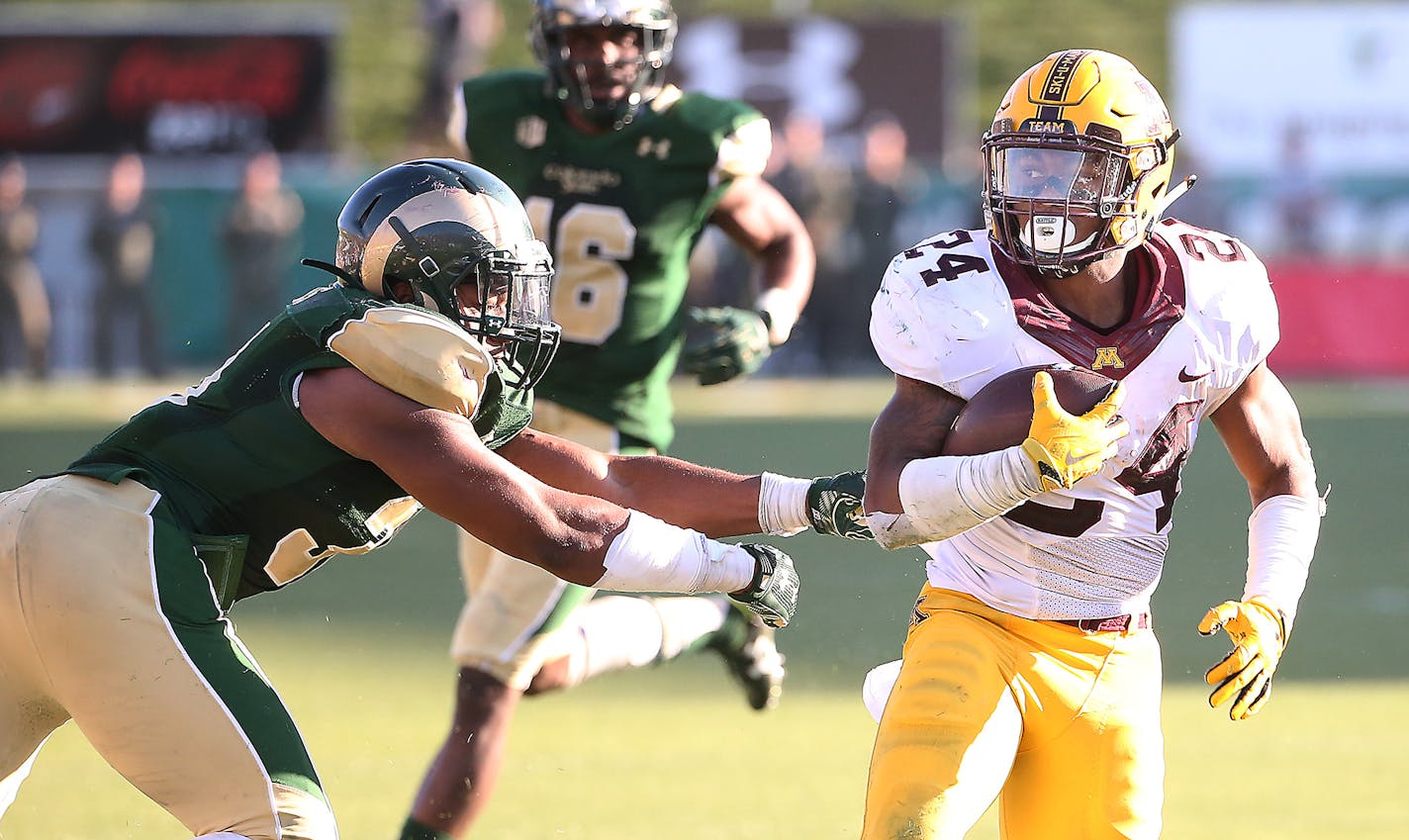 Minnesota running back Rodney Smith ran the ball despite defensive pressure by Colorado State linebacker Cory James in overtime as Minnesota took on Colorado State at Sonny Lubick Field at Hughes Stadium, Saturday, September 12, 2015 in Ft. Collins, CO. ] (ELIZABETH FLORES/STAR TRIBUNE) ELIZABETH FLORES &#x2022; eflores@startribune.com ORG XMIT: MIN1509122004300365