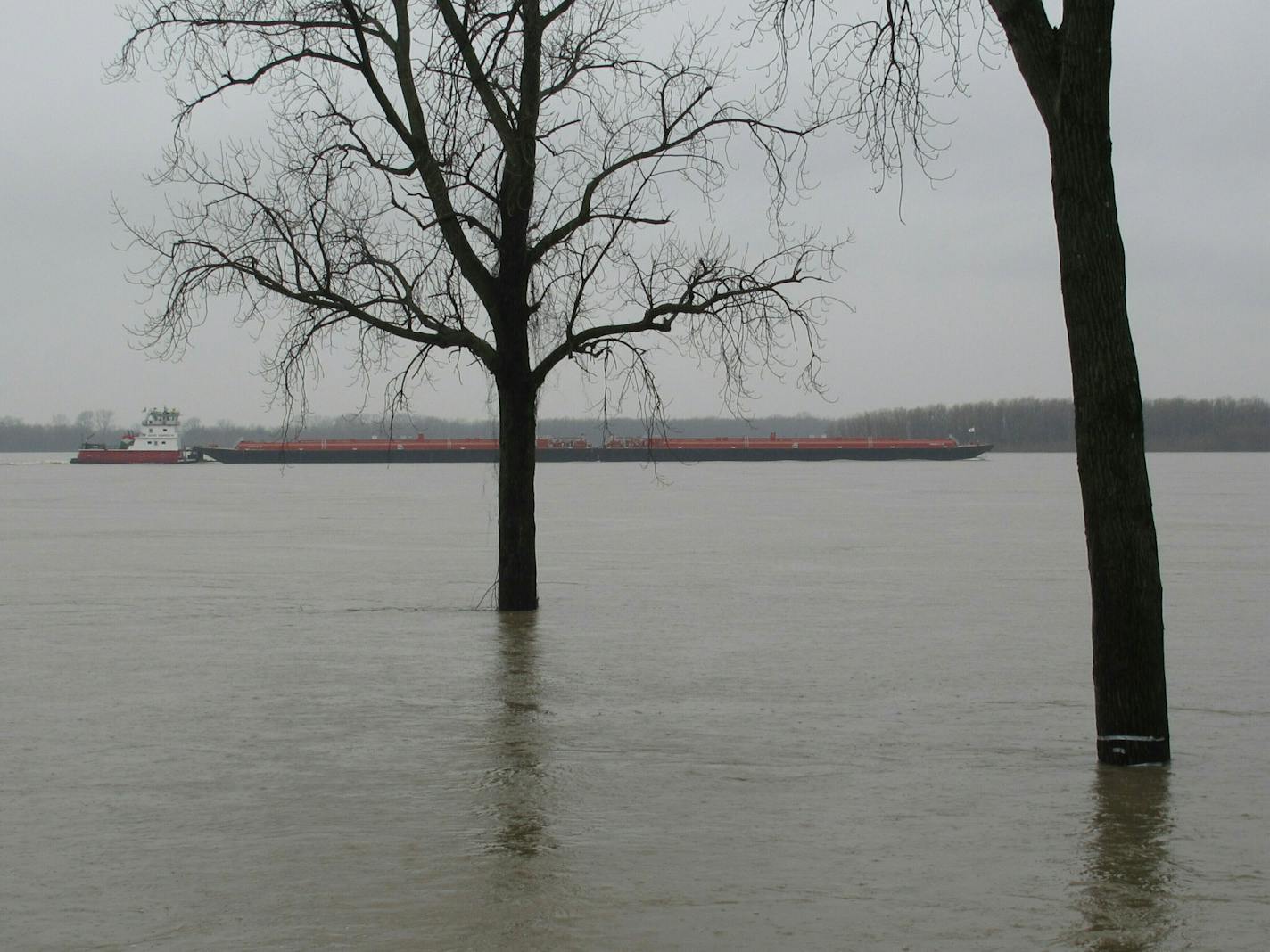 A barge cruises past a low-lying Memphis park flooded by the swollen Mississippi River at the end of February. High waters along the river are causing issues for transporting grain. (AP Photo/Adrian Sainz).