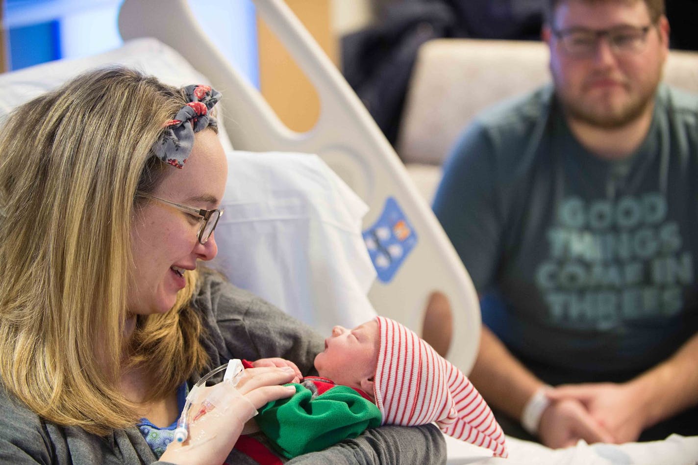 Hannah Lindeman held her newborn daughter, Poppy, in her hospital room Monday night. Sitting behind Hannah is her husband, Taylor, who delivered Poppy on the side of a road in Chisago City earlier Monday. ] AARON LAVINSKY &#xef; aaron.lavinsky@startribune.com Taylor Lindeman delivered his family's best Christmas present Monday along a frigid roadside in Chisago City shortly after his pregnant wife Hannah said he'd better call an ambulance. We photograph Taylor, Hannah and their newborn daughter,