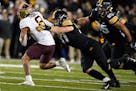 Iowa defensive lineman Zach VanValkenburg tackles Minnesota running back Ky Thomas (8) during the second half of an NCAA college football game, Saturd