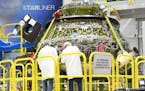 Boeing technicians work August 9, 2018 on the Starliner spacecraft inside Boeing's production facility at the Kennedy Space Center. (Red Huber/Orlando