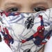 A boy wears a protective face mask with a Spiderman motif as a measure to help curb the spread of the new coronavirus, in Bogota, Colombia, Thursday, 