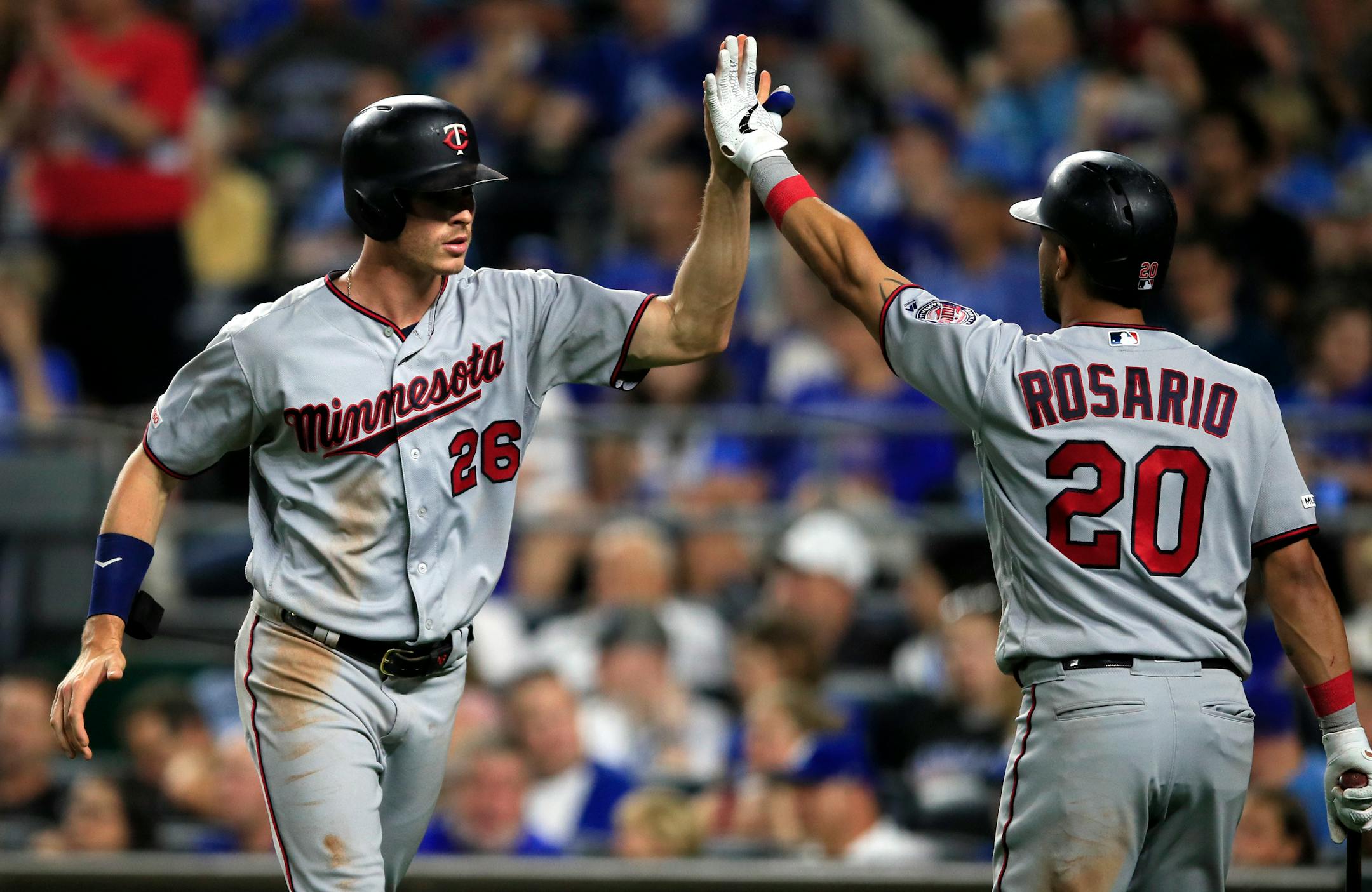 The Twins' Max Kepler is congratulated by Eddie Rosario after scoring during the seventh inning
