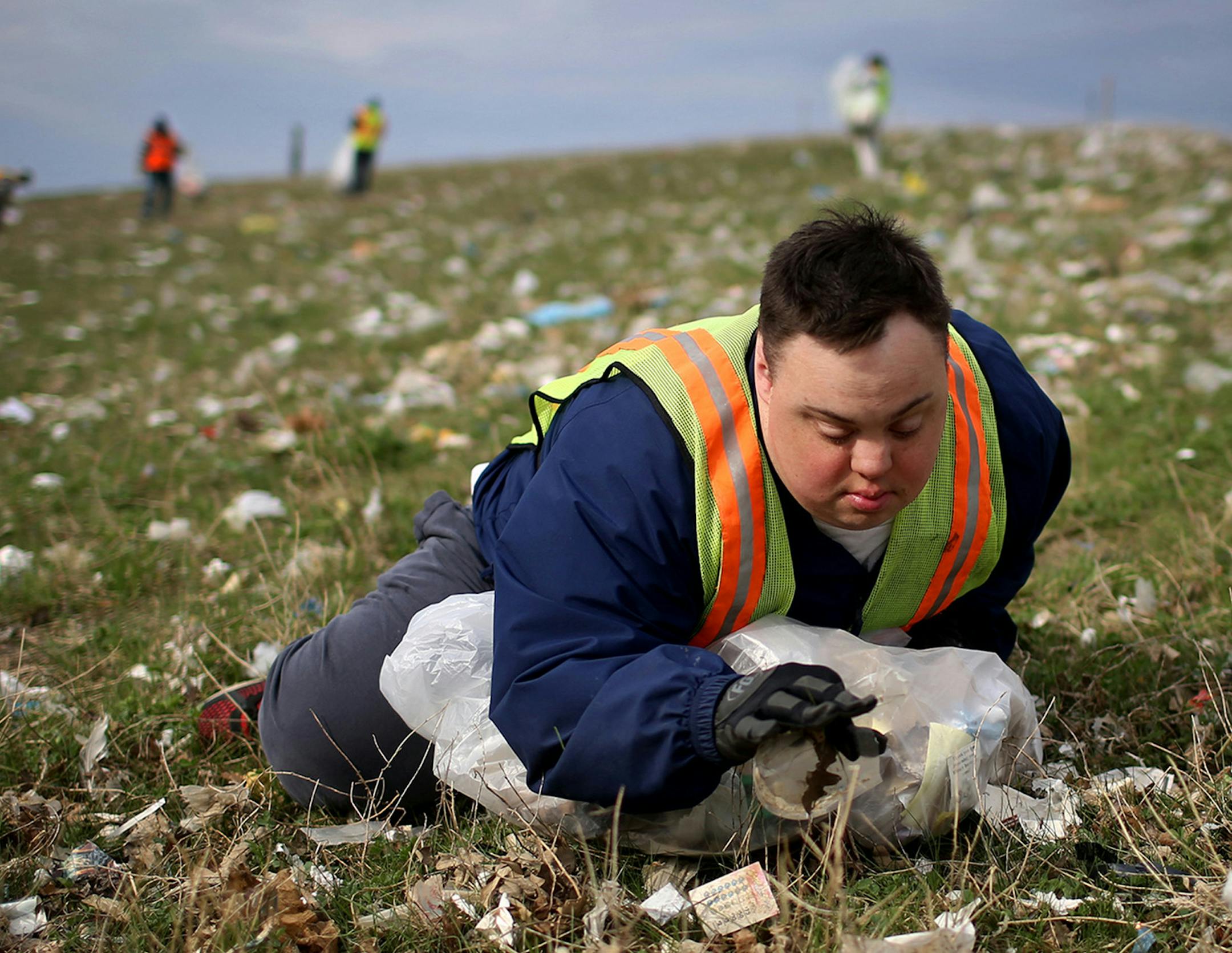 Scott Rhude picks up trash for his workshop job last year. (David Joles/Minneapolis Star Tribune/TNS)