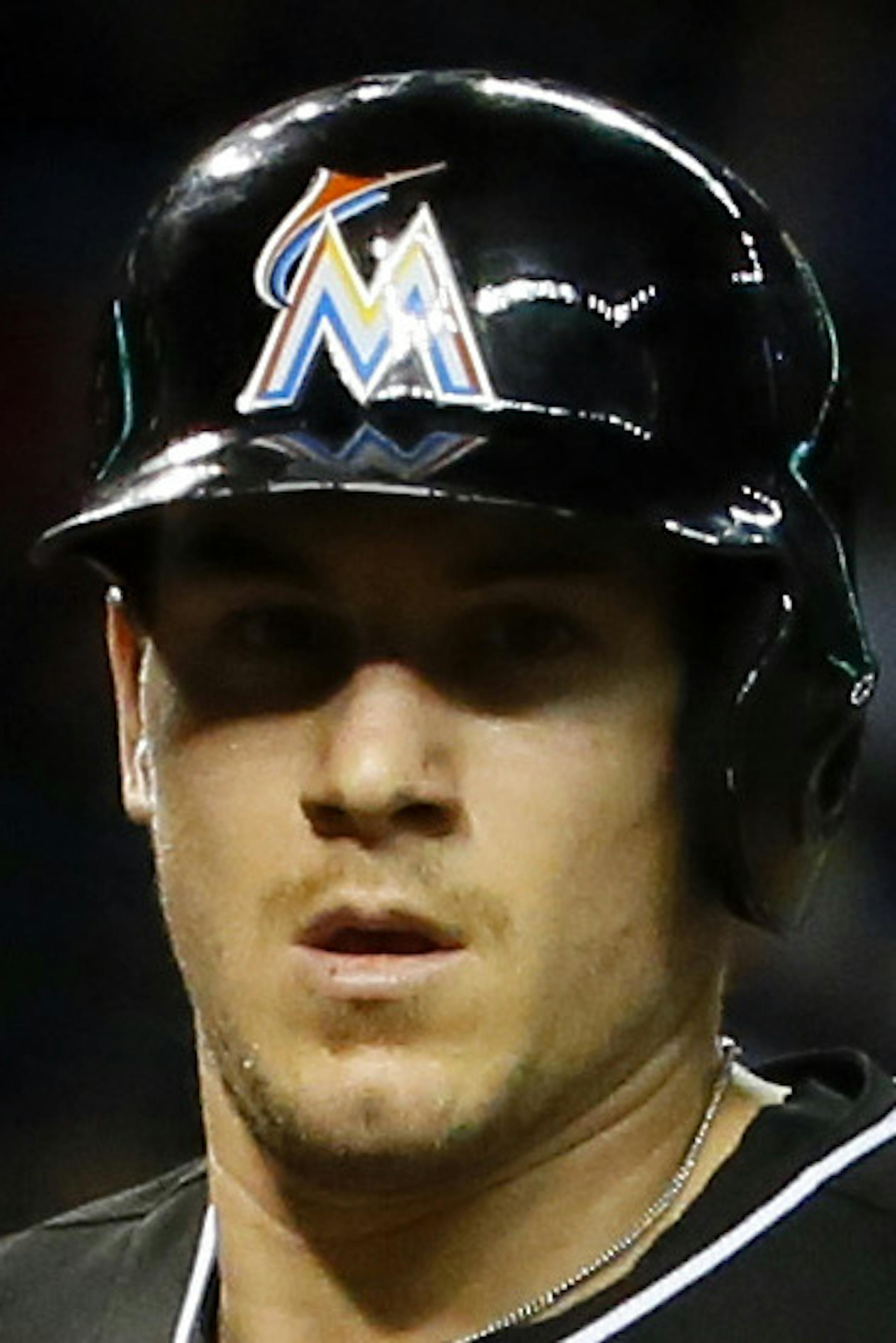 Miami Marlins' J.T. Realmuto scores on a base hit by teammate Adeiny Hechavarria during the fifth inning of a baseball game against the Arizona Diamondbacks Tuesday, July 21, 2015, in Phoenix. (AP Photo/Matt York)