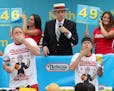 Joey Chestnut, left, competed in 2015 in the Nathan's Famous Hot Dog eating contest,