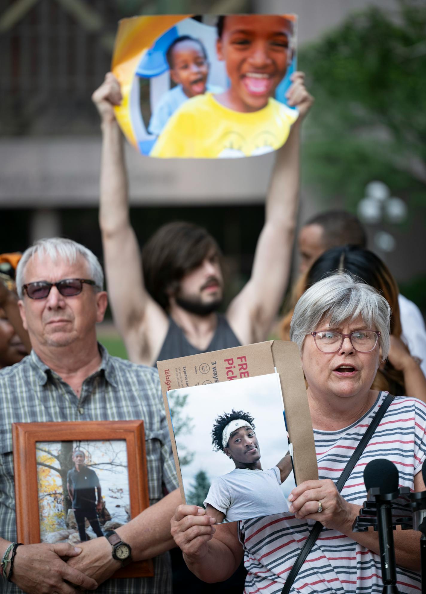 Cindy and Mark Sundberg, whose son, Tekle Sundberg, was shot and killed by Minneapolis Police during a standoff last year, held photos of their son while speaking during a rally outside the Hennepin County Government Center Friday, June 16, 2023, in Minneapolis, Minn. The US Department of Justice released the findings in its sweeping investigation into the Minneapolis Police Department finding it routinely engaged in a pattern of racist and abusive behavior. ] AARON LAVINSKY • aaron.lavinsky@startribune.com